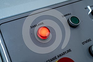 Power button illuminated on control panel, closeup industrial