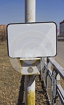 The power button traffic lights at the crosswalk with a blank sign.