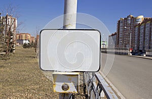 The power button traffic lights at the crosswalk with a blank sign.