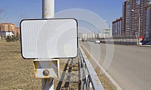 The power button traffic lights at the crosswalk with a blank sign. On an empty sign can be applied to the inscription of any