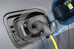 Power cable connected with a charger plugged into electric car