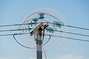 Power cables on a pole with the ceramic isolators