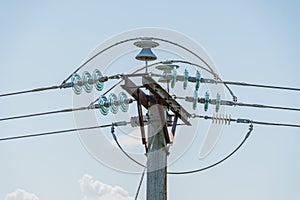 Power cables on a pole with the ceramic isolators