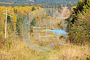 A power cutline running through an autumn forest