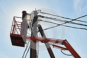 Power electrician lineman at work on pole