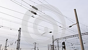 Power electricity wire trains against sky. Close up of railway electrification