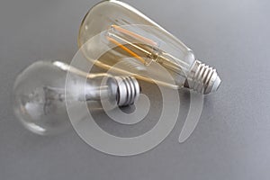 Power energy saving concept. light bulb with light on on gray background.