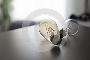 Power energy saving concept. light bulb with light on on gray background.