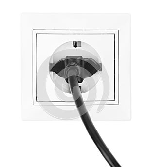 Power European electric plug isolated on a white. black electric cord plugged into a white electricity socket on white background