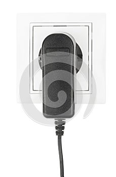 Power European electric plug isolated on a white. black electric cord plugged into a white electricity socket on white background