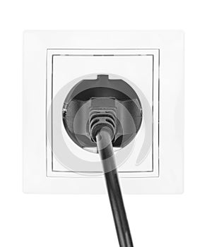 Power European electric plug isolated on a white. black electric cord plugged into a white electricity socket on white background