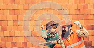 Power. Force. Strong workers. Little boy and his father on a background of a construction site. Contractor. Contract for