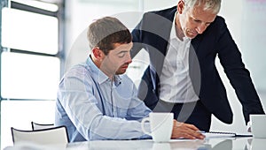 Power is gained by sharing knowledge. two businesspeople having a discussion in a corporate office.