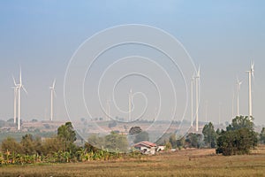 Power-generating wind turbine and greenfield photo
