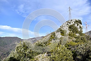 Power grid seen from the mountains in Apuane Alps Regional Park. Tuscany, Italy. photo