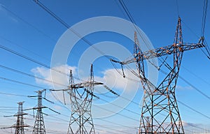 power high voltage tower over blue sky