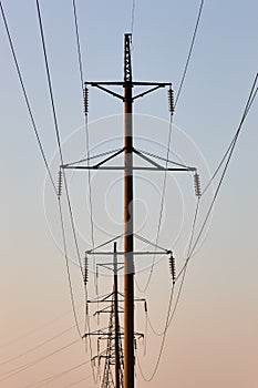 Power line against the backdrop of the setting sun