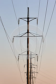 Power line against the backdrop of the setting sun