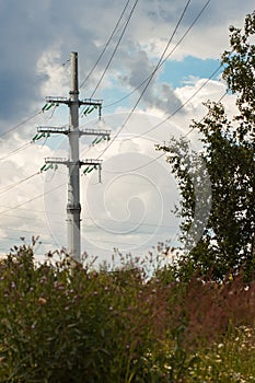 Power line consists of conductors suspended by towers or poles. photo