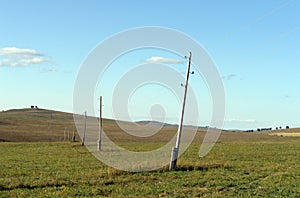 Power line in the foothills of the Altai territory. Western Siberia. Russia