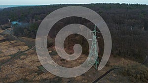 Power line in forest. High-voltage tower, aerial view. Energy efficiency conception. Transmission tower. Electricity pylon