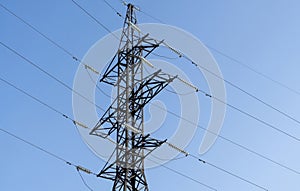 Power line. High-voltage power transmission tower with wires. High voltage line. Energy industry. Energy transfer over blue sky.