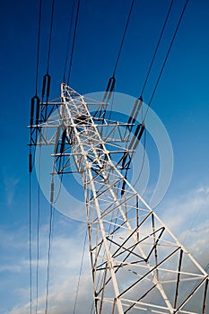 Power line pole over blue sky background