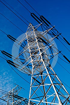 Power line pole over blue sky background