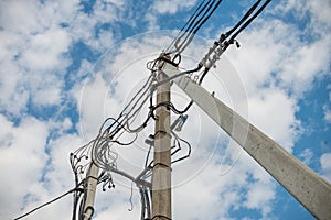 Power line post with an electric wires and telephone lines. Low-angle shot. Equipment, communication. Copy space for text