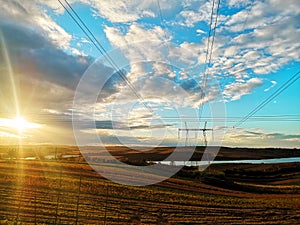 Power line pylon at sunset. Beautiful natural landscape background.