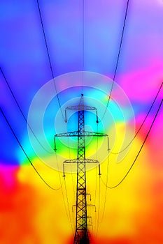 Power line pylons against colorful background