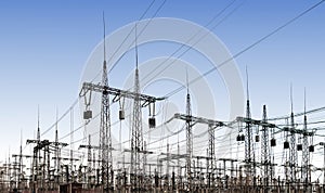 Power line pylons and transformers in the daytime. distribution, transmission and consumption of electricity