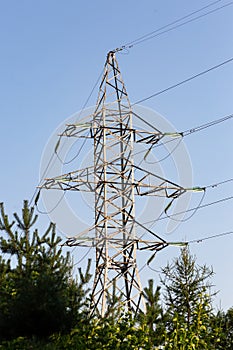 Power line support is located in the forest part of the outdoor. Transmission of electricity, the high tower