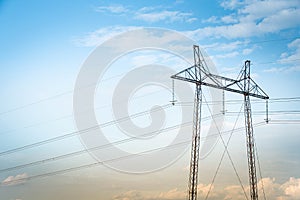 Power line tower against sky and clouds