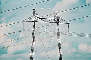 Power line tower against sky and clouds