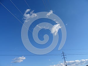 power line tower with a beautiful sky and clouds