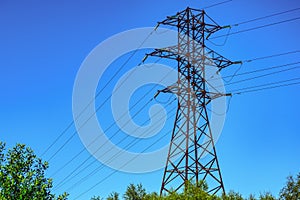 Power line towers against of the blue sky