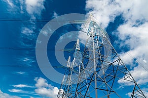 Power line towers against the blue sky