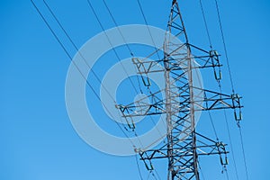 Power line towers against of the blue sky