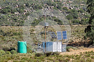 Power line, transformer, solar backup, water tank on Nieuwoudt Pass