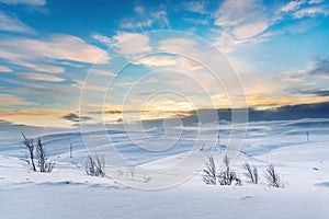 Power line traverses a snow covered remote region in the Arctic