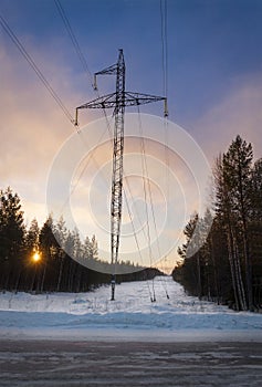 Power line in winter at dawn