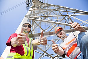 power line workers with thumbs up