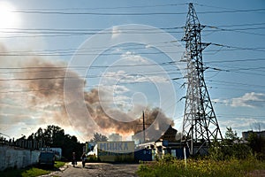 Power lines against the background of blue sky and black smoke on June 3, 2016 in Kiev