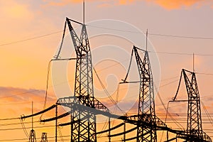 Power lines against the sunset sky. Electrical substation