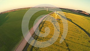 Power lines and agricultural field. Sunset