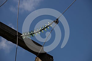 Power lines on background of blue sky close-up. Electric hub on pole. Electricity equipment with copy space. Wires of