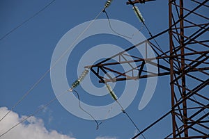 Power lines on background of blue sky close-up. Electric hub on pole. Electricity equipment with copy space. Wires of