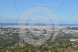 Power lines with background the city of Chania in Greece