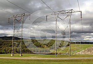 Power lines on a gray sky with mountains